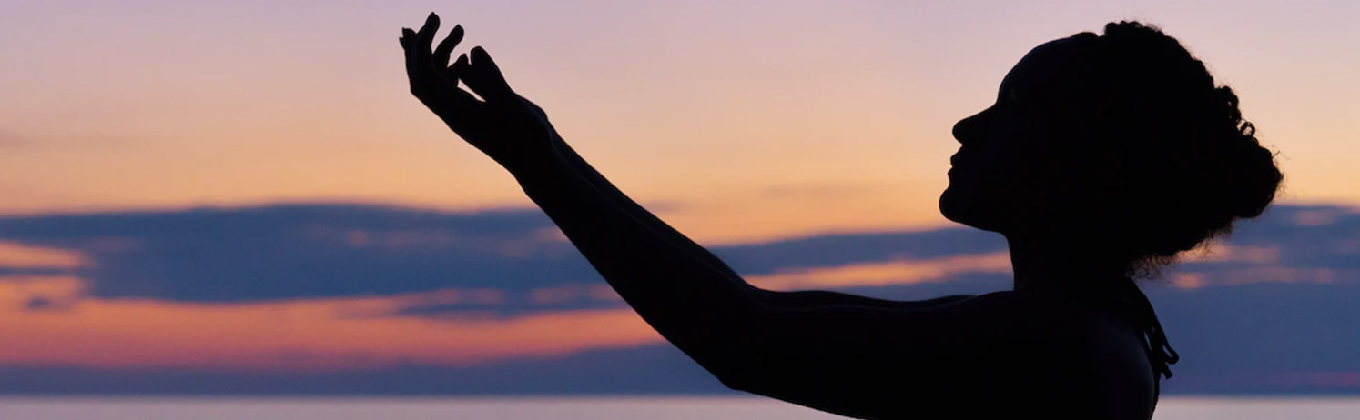 Silhoutte A woman stretching out her arms